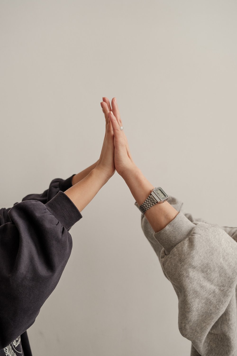 Mother and Daughter's Hands High Fiving Together